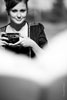 Черно-белый фотопортрет девушки с фотокамерой в руках
